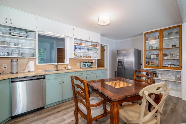 dining room with light wood-style floors and crown molding