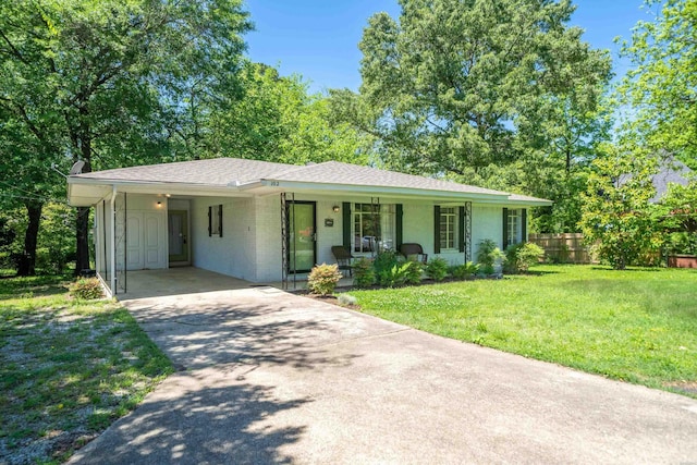 ranch-style house featuring a porch, a front lawn, an attached carport, driveway, and fence