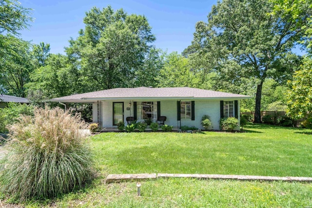 ranch-style home with a porch, a front lawn, and fence