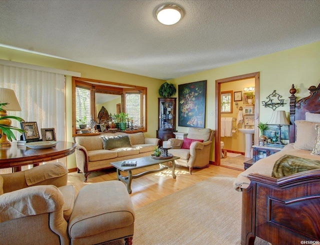 living room featuring a textured ceiling and light wood-type flooring