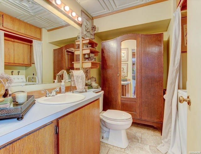 bathroom featuring toilet, vanity, and an ornate ceiling