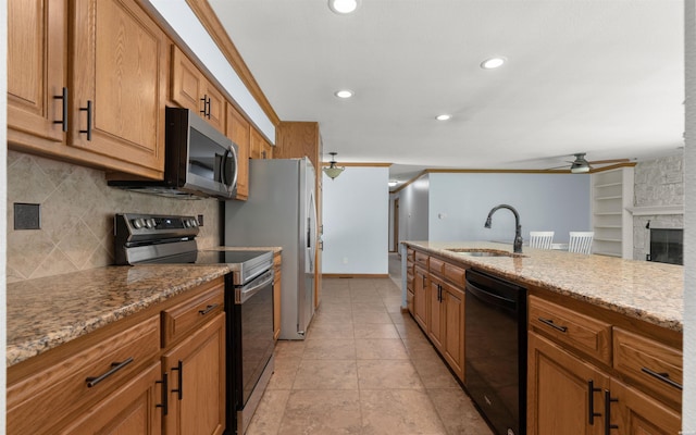 5 Arga Pl, Hot Springs, AR 71909 - kitchen featuring stainless steel appliances, ceiling fan, decorative backsplash, brown cabinets, and light stone counters