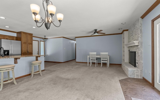 5 Arga Pl, Hot Springs, AR 71909 - kitchen featuring stainless steel refrigerator with ice dispenser, brown cabinets, a ceiling fan, light colored carpet, and a kitchen bar