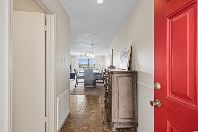 5371 Central Ave Unit 6E, Hot Springs, AR 71913 - hall featuring a textured ceiling, dark tile patterned floors, and dark carpet