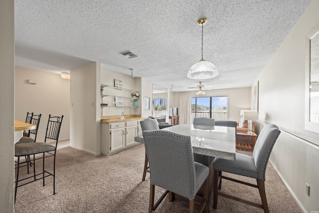 5371 Central Ave Unit 6E, Hot Springs, AR 71913 - dining room featuring light carpet, a textured ceiling, and ceiling fan