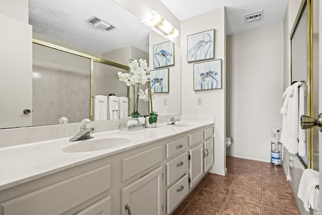 5371 Central Ave Unit 6E, Hot Springs, AR 71913 - full bathroom with double vanity, a textured ceiling, a shower with shower door, and tile patterned floors