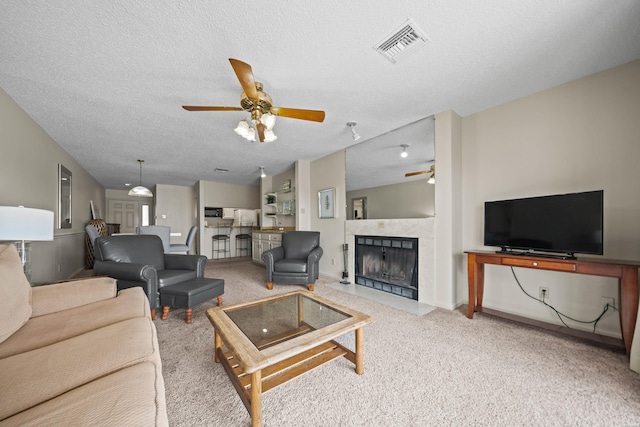 5371 Central Ave Unit 6E, Hot Springs, AR 71913 - living area featuring ceiling fan, carpet, a premium fireplace, and a textured ceiling