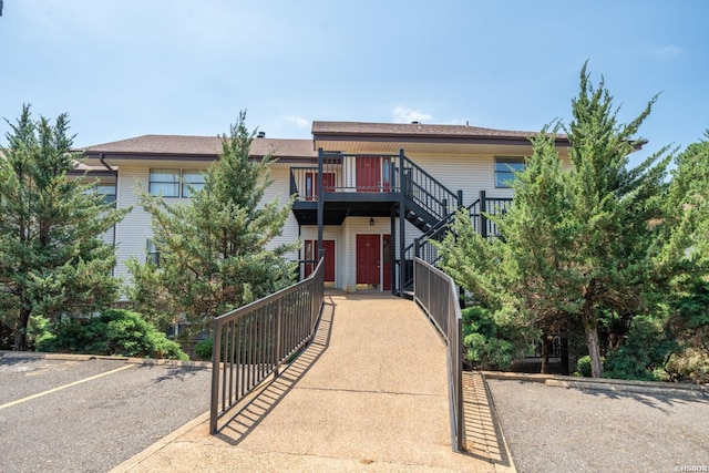 multi unit property with stairway and a wooden deck