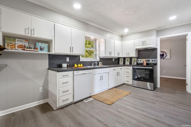 kitchen featuring stainless steel range with electric stovetop, dark countertops, dishwasher, and open shelves