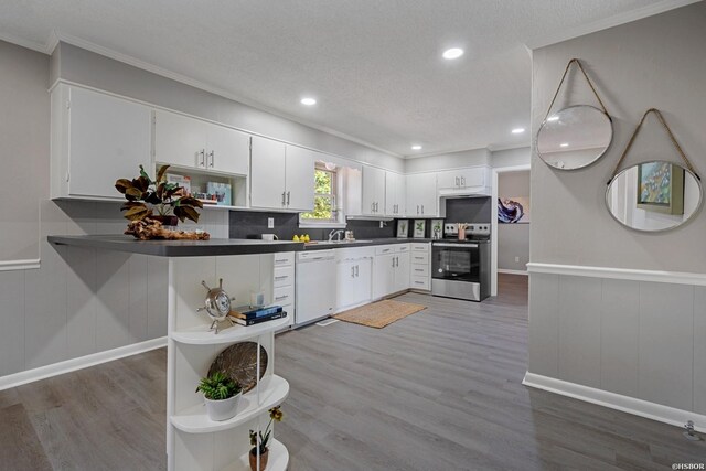 kitchen with dark countertops, white cabinets, and stainless steel electric stove