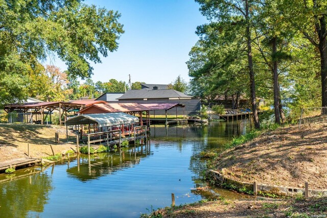 dock area featuring a water view and boat lift