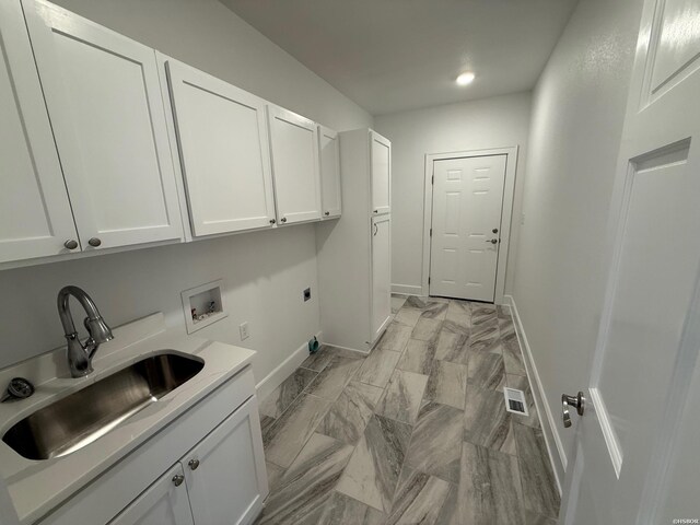 clothes washing area featuring hookup for a washing machine, a sink, baseboards, cabinet space, and electric dryer hookup