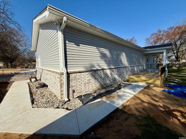 view of property exterior featuring brick siding