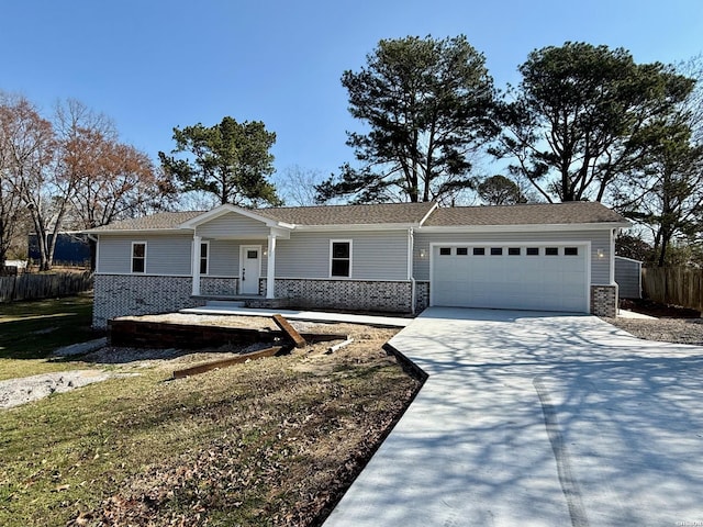 single story home with a garage, fence, concrete driveway, and brick siding