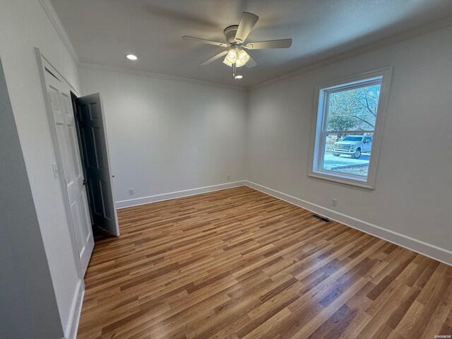 unfurnished bedroom with crown molding, recessed lighting, ceiling fan, wood finished floors, and baseboards