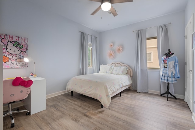 bedroom featuring baseboards, a ceiling fan, and wood finished floors