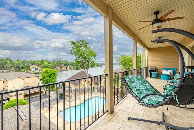 balcony with a water view and ceiling fan