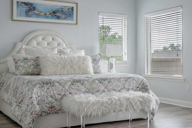 bedroom featuring baseboards and wood finished floors