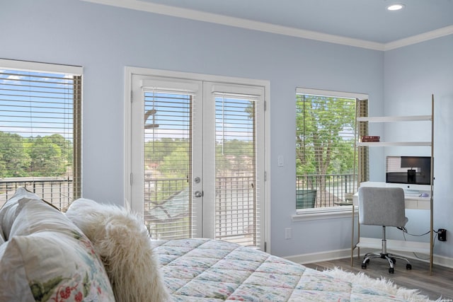 bedroom featuring crown molding, baseboards, wood finished floors, and access to exterior