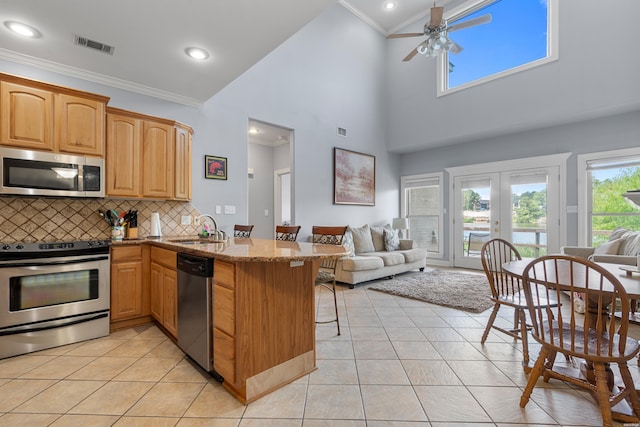 181 Fish Hatchery Rd Unit P2, Hot Springs, AR 71913 - kitchen featuring stainless steel appliances, open floor plan, crown molding, stone countertops, and light tile patterned floors