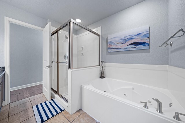 bathroom featuring a whirlpool tub, a shower stall, and tile patterned floors