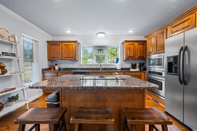 kitchen with a kitchen breakfast bar, a kitchen island, and black appliances