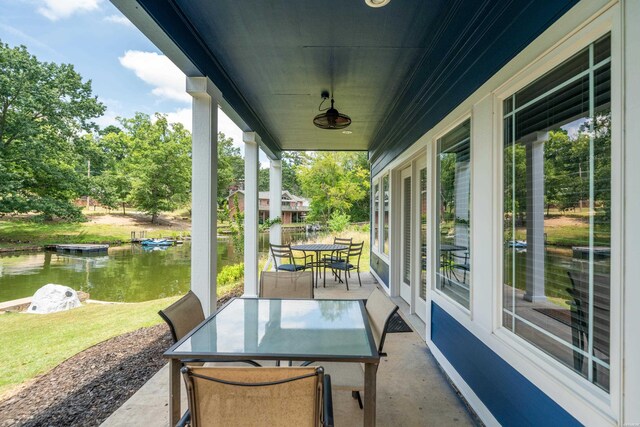 view of patio / terrace featuring outdoor dining area and a water view