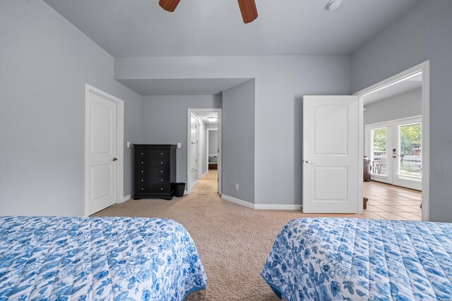 bedroom featuring baseboards, ceiling fan, and light colored carpet