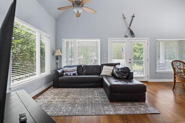 living area featuring high vaulted ceiling, wood finished floors, a ceiling fan, baseboards, and french doors