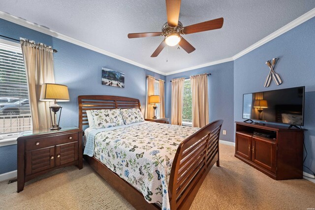 bedroom featuring ornamental molding, light carpet, a textured ceiling, and baseboards