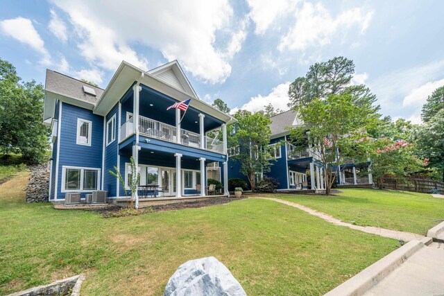 back of house featuring a patio area, a yard, and a balcony