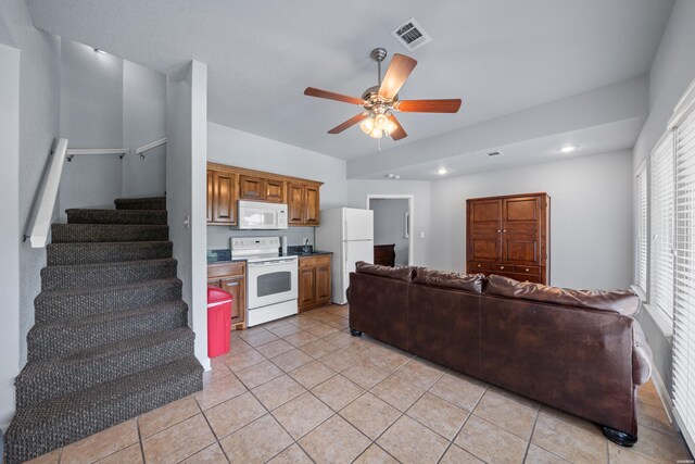 kitchen with white appliances, visible vents, ceiling fan, open floor plan, and light tile patterned flooring