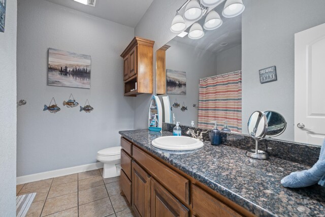 full bathroom with a shower with shower curtain, toilet, vanity, tile patterned flooring, and baseboards