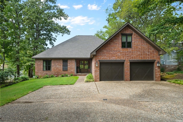 view of front of home featuring a garage, concrete driveway, brick siding, and a front lawn