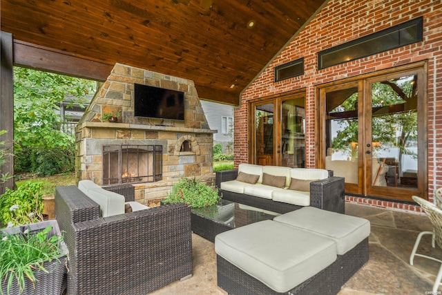 view of patio / terrace with french doors and an outdoor living space with a fireplace