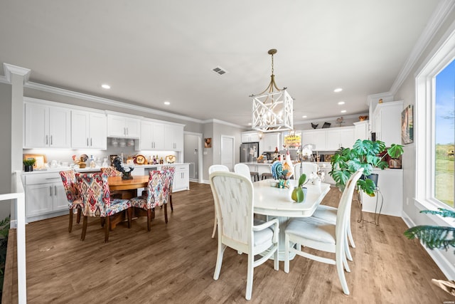 150 Villa Pointe Pt Unit A, Hot Springs, AR 71913 - dining area featuring crown molding, healthy amount of natural light, wood finished floors, a chandelier, and recessed lighting
