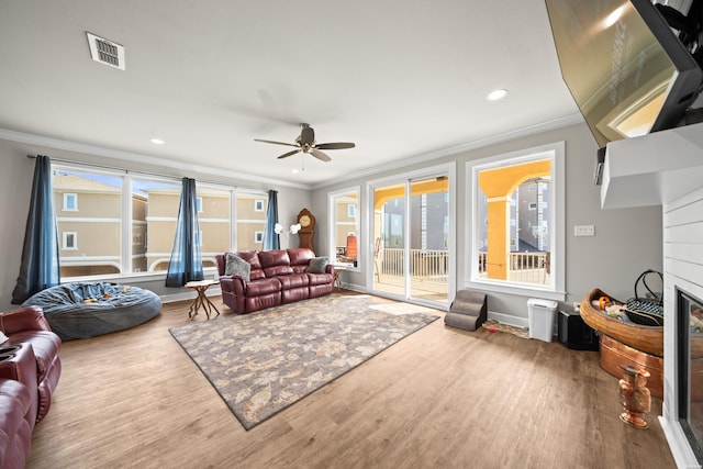 150 Villa Pointe Pt Unit A, Hot Springs, AR 71913 - living area featuring crown molding, wood finished floors, a glass covered fireplace, a ceiling fan, and recessed lighting