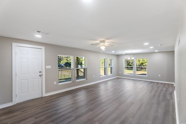 unfurnished living room with a ceiling fan, baseboards, visible vents, and dark wood-type flooring