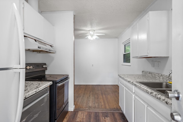 kitchen featuring black electric range oven, freestanding refrigerator, white cabinetry, a textured ceiling, and under cabinet range hood