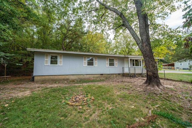 ranch-style home with crawl space, fence, and a front lawn