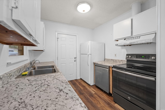 kitchen featuring black / electric stove, a sink, white cabinets, freestanding refrigerator, and custom range hood