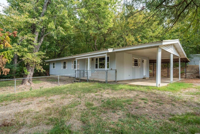 single story home featuring an attached carport, a front yard, and fence private yard