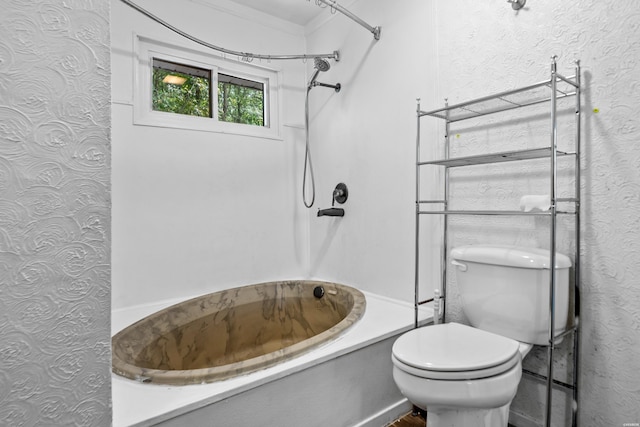 bathroom with a textured wall, shower / bath combination, and toilet