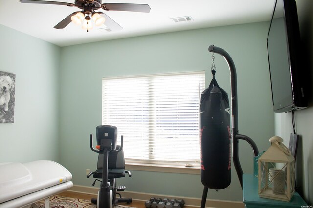 workout area featuring ceiling fan, visible vents, and baseboards