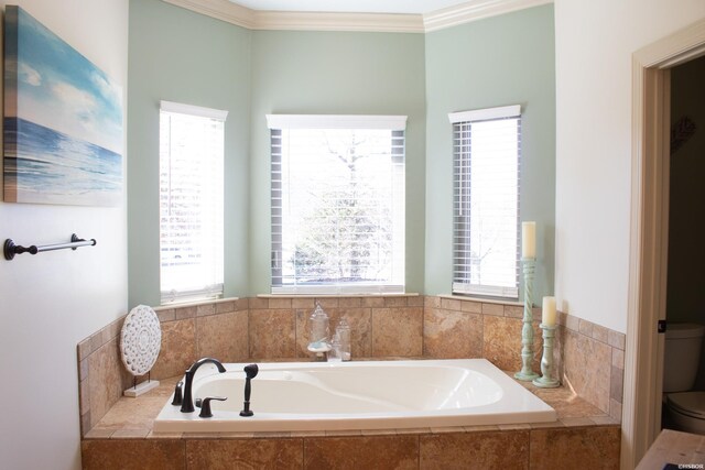 full bath featuring a wealth of natural light, crown molding, toilet, and a bath