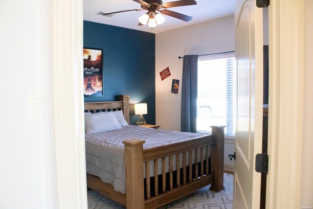 bedroom with ceiling fan, multiple windows, and visible vents