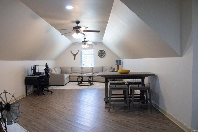 living room with lofted ceiling, baseboards, and wood finished floors