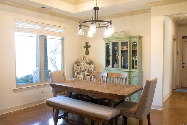 dining area with a raised ceiling, visible vents, crown molding, and baseboards