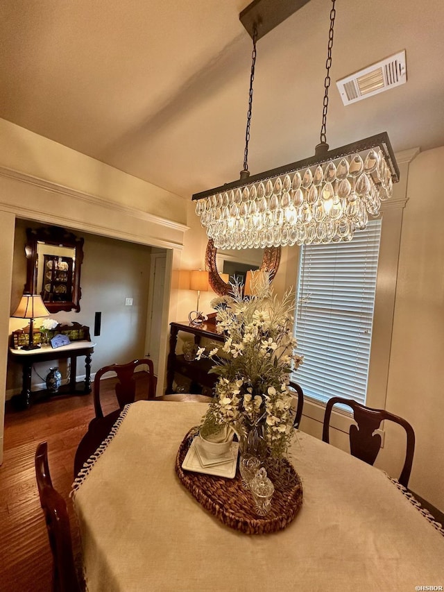 dining space with wood finished floors and visible vents