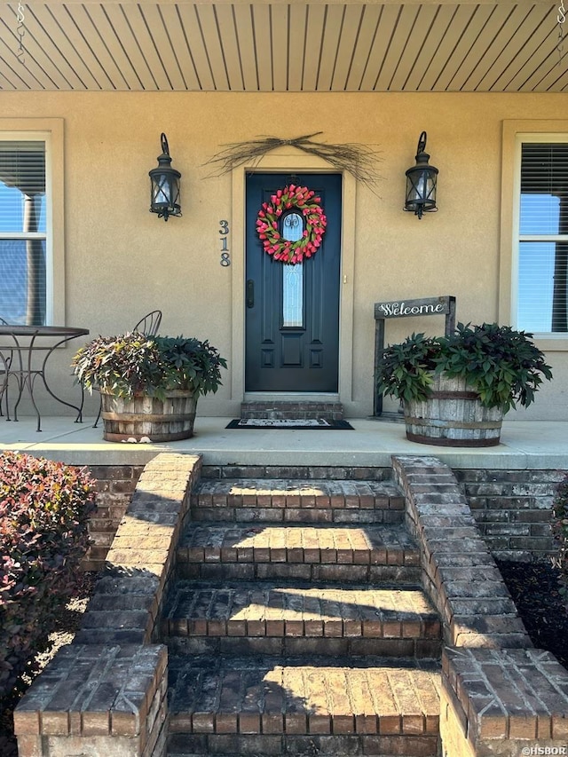 doorway to property with stucco siding